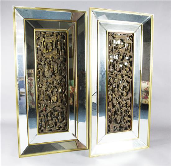 A pair of Chinese giltwood panels with later bevelled mirror frames, 150.5 x 75cm